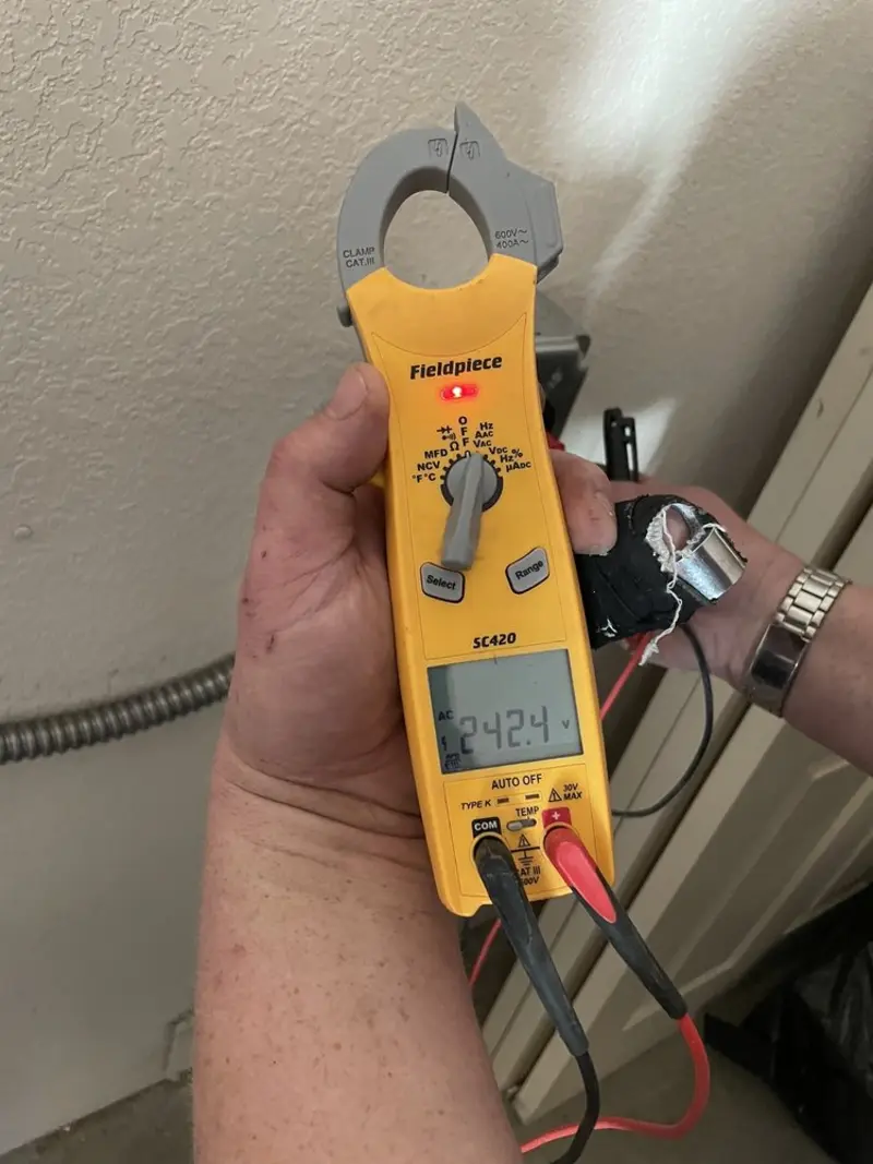 Voltage testing with clamp meter during Whole House Surge Protector in Lansing
